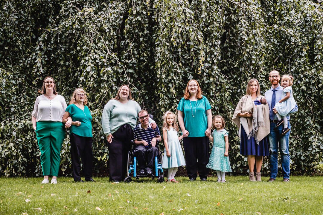 Untitled Families - family of 11 standing together in front of large tree