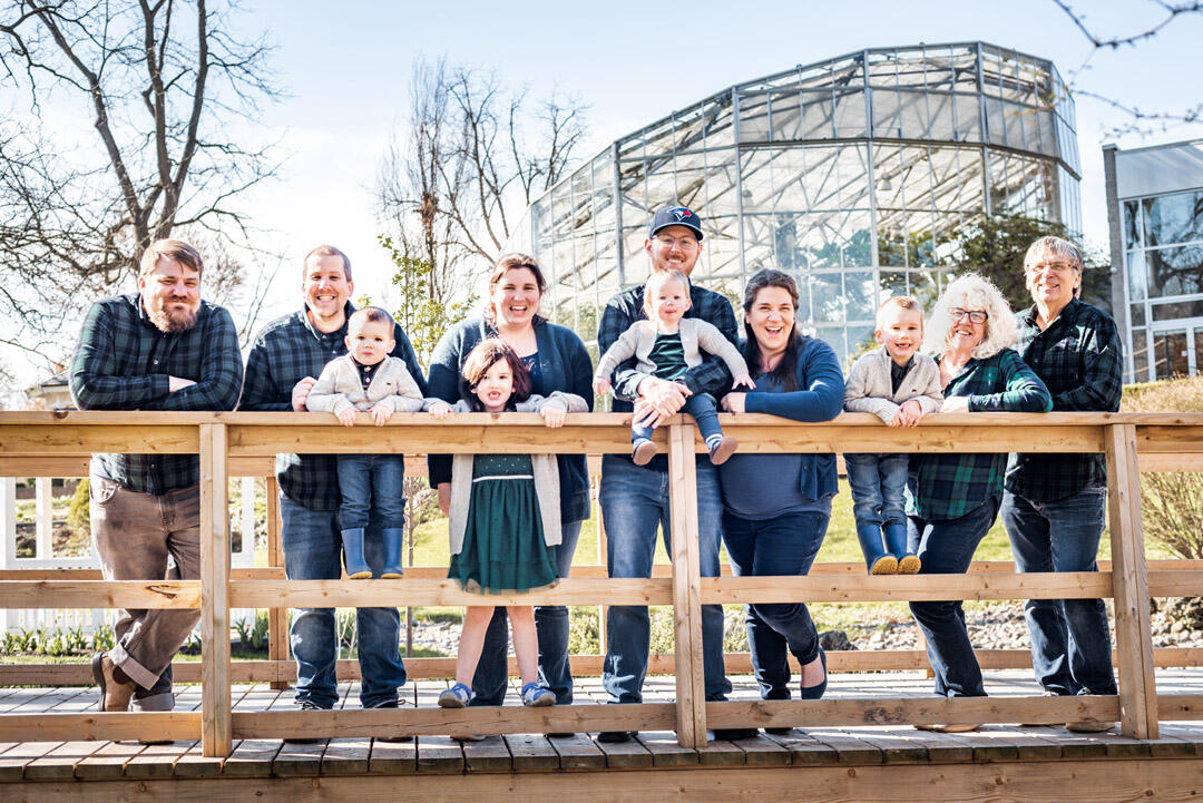 Untitled Family - Large family leaning against a bridge railing, smiling