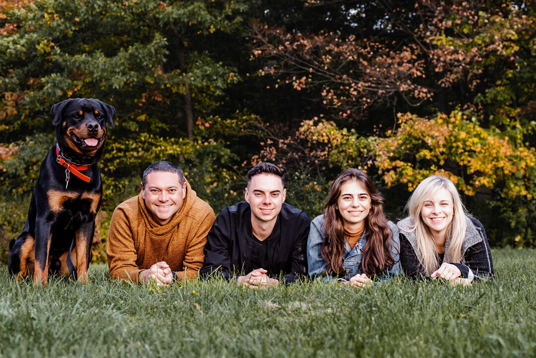 Untitled Families - family of 4 adults with dog lying on ground, facing camera