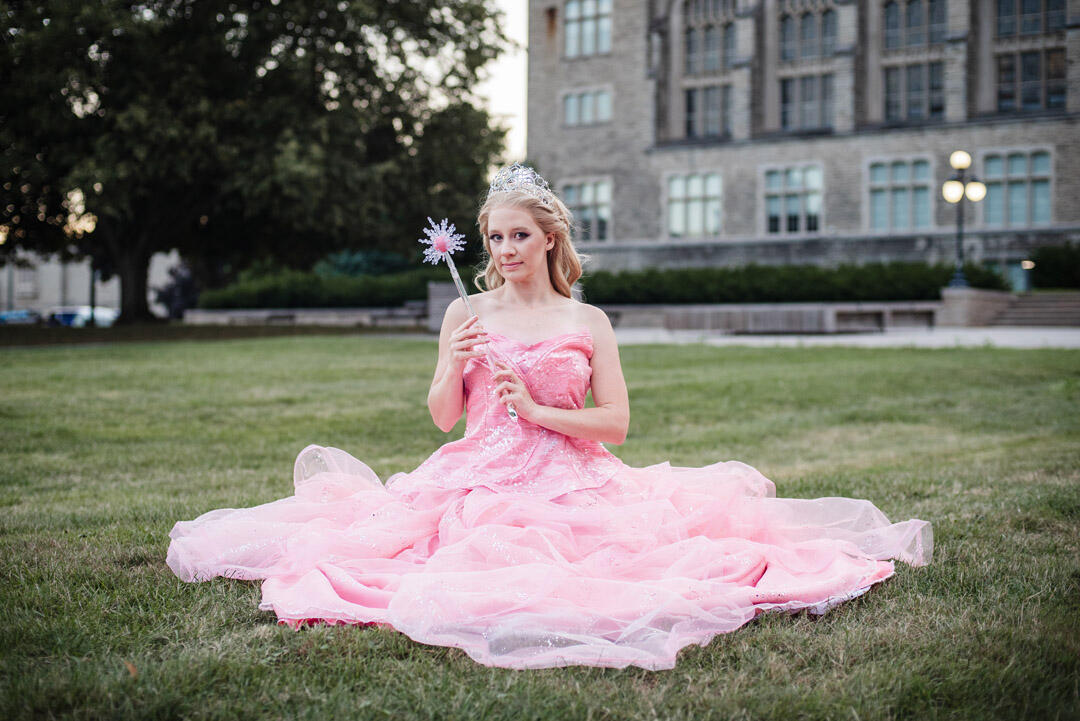Untitled Styled Shoot - Glinda cosplay sitting in grassy field, holding wand