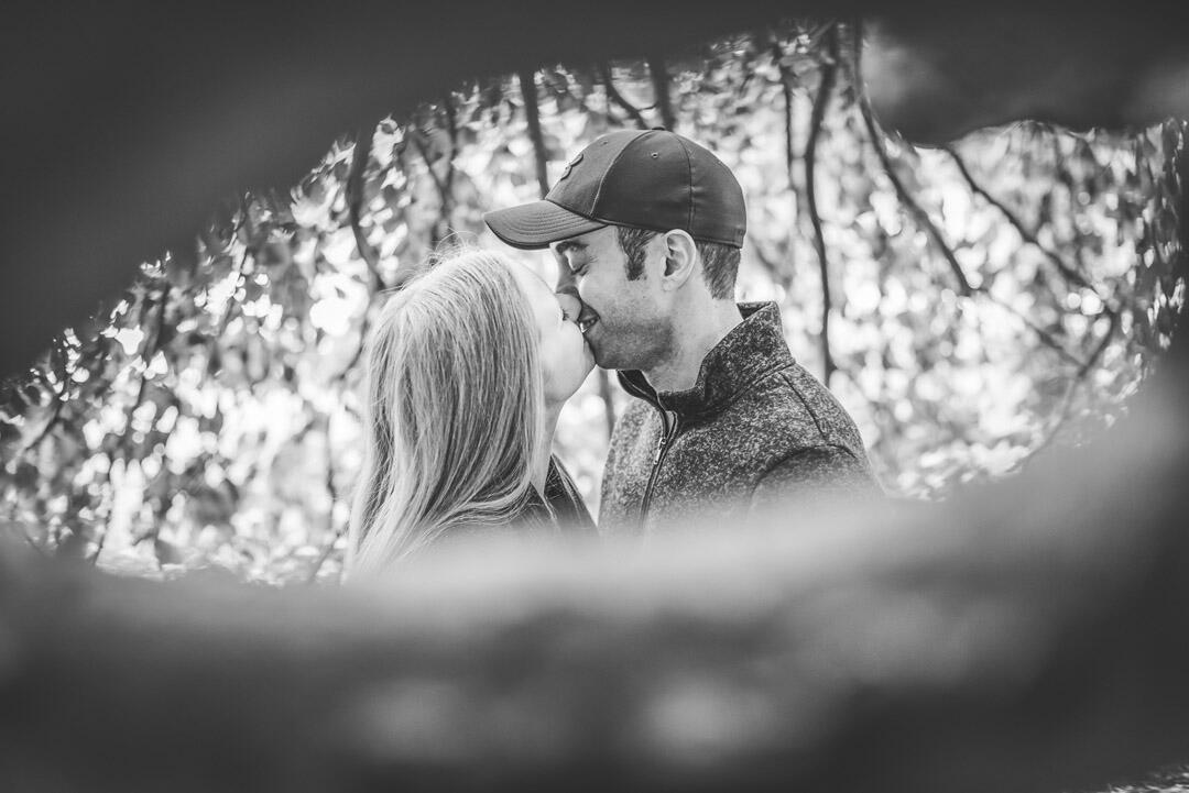 Untitled Couple - kissing; looking through a hole in a tree