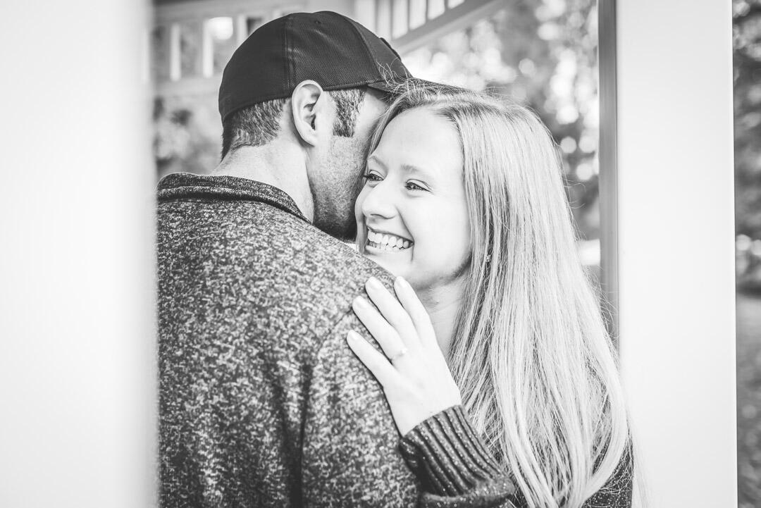 Untitled Couple - man whispering into woman's ear while she laughs