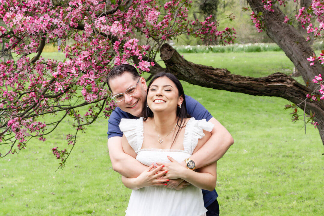 Untitled Couple - hugging and laughing under a blossom tree