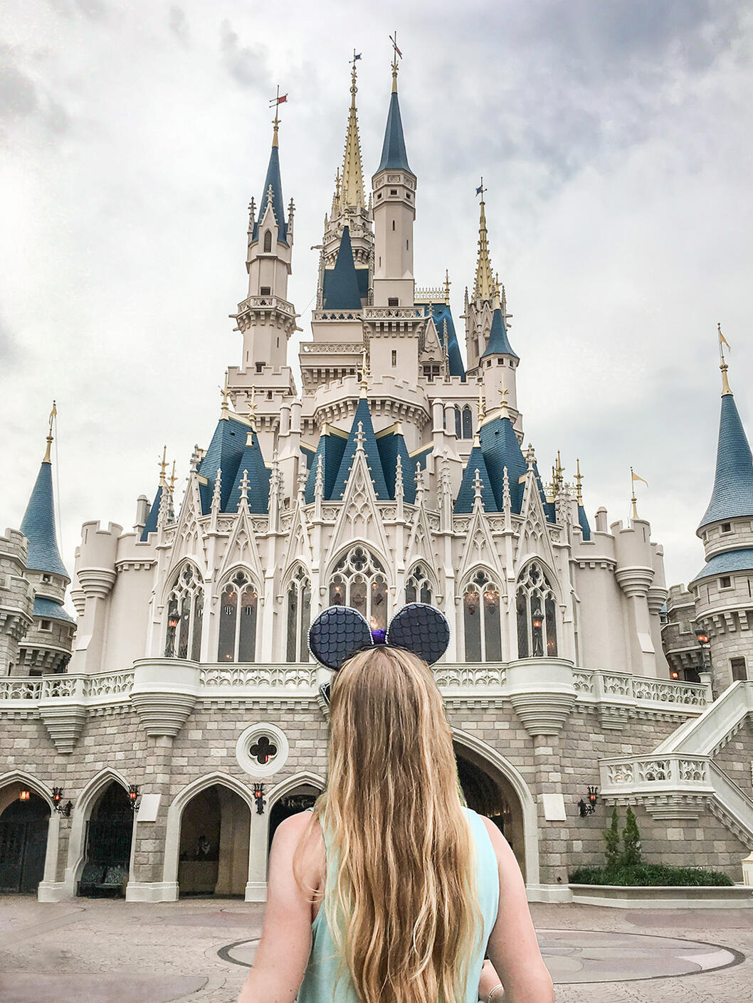 Shannon facing the Cinderella castle at Disney world